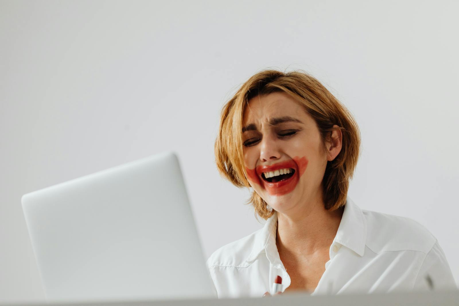 Crying Woman with her Face Smeared with Red Lipstick