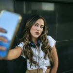 Young woman taking a selfie with her smartphone, pouting mouth
