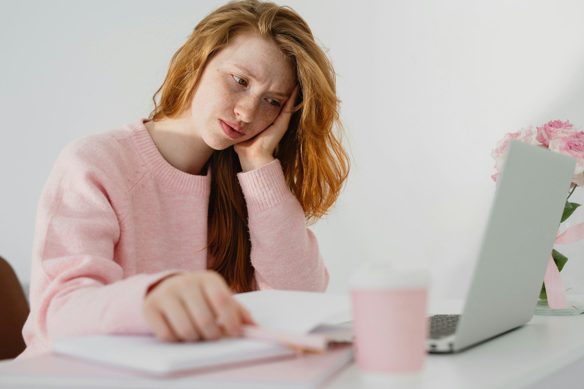 Close up of frustrated woman looking at laptop screen.